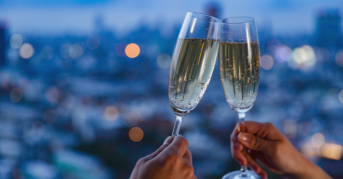 Two hands cheersing glasses of sparkling wine