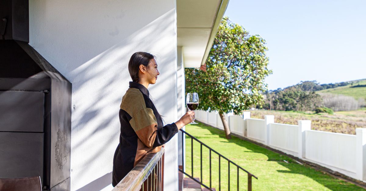 Lady drinking wine on the balcony