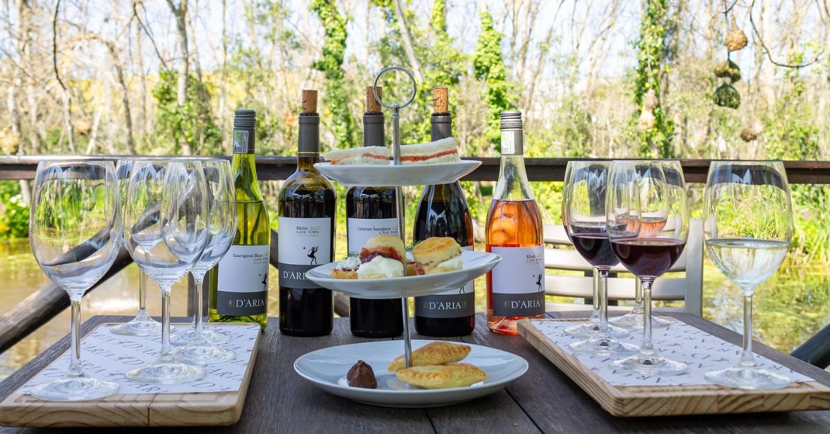 wine pairing durbanville - A setup of D'Aria Wines and a tiered cake stand with snacks on it