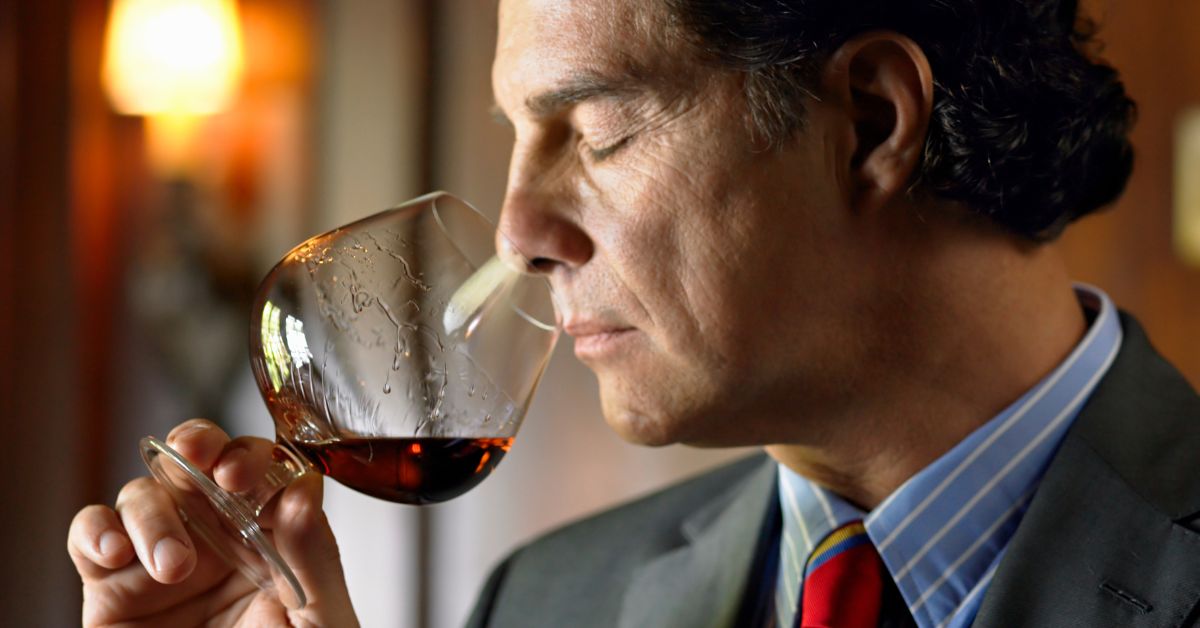 A man smelling a glass of brandy