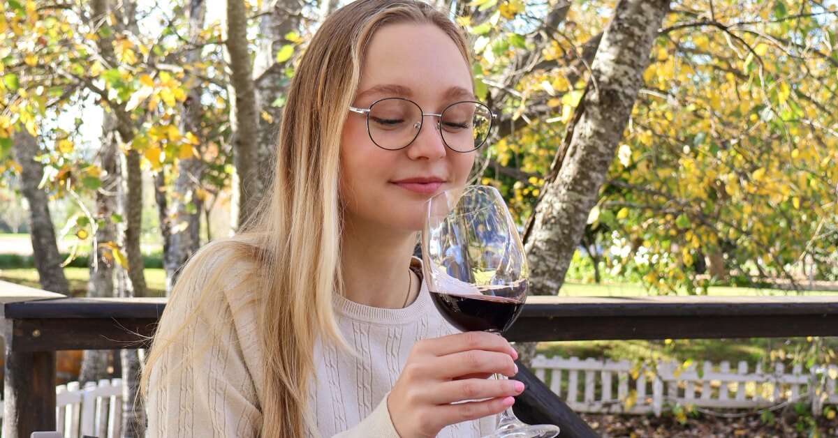 Lady admiring a glass of D'Aria Red Wine