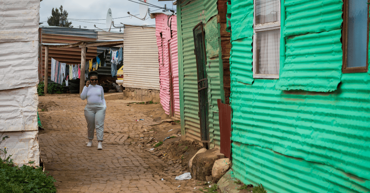 Person walking through a colourful township neighbourhood in Khayelitsha
