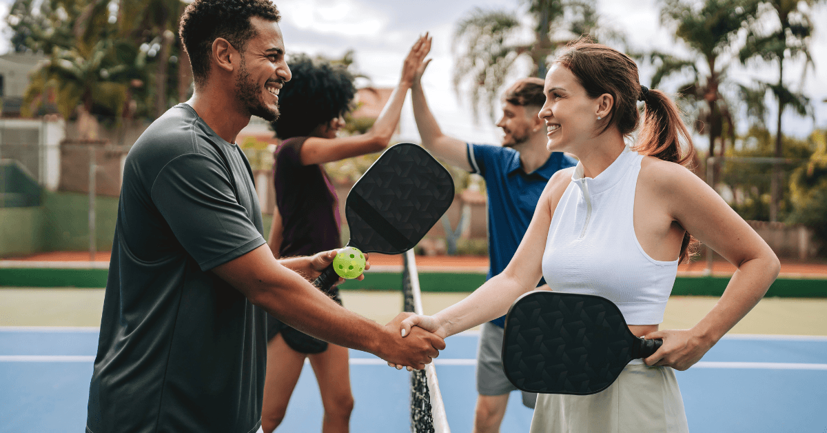 People playing padel together during a team-building activity