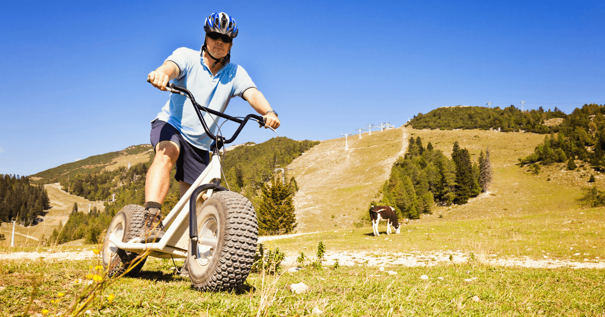 Person riding a mountain scooter through Banhoek Valley